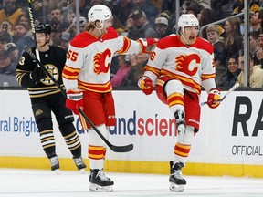Andrei Kuzmenko #96 of the Calgary Flames celebrates his goal with Noah Hanifin #55 against the Boston Bruins during the first period at the TD Garden on Feb. 6 in Boston. Former Canuck Kuzmenko will be in Vancouver to face his old team on Saturday, March 23.
