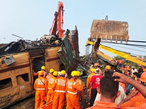 Members of the National Disaster Response Force (NDRF) conduct rescue operation at the site of train crash in Vizianagaram district of India's Andhra Pradesh state on Oct. 30, 2023.