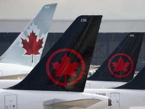 Air Canada logos are seen on the tails of planes at the airport in Montreal, Que., on June 26, 2023.