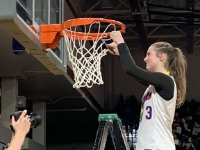 Brookswood Bobcats guard Jordyn Nohr takes her turn at the ceremonial mesh cutting after her team's win over the St. Michaels University School Blue Jags in Saturday's Triple A girls basketball provincial final at the Langley Events Centre.