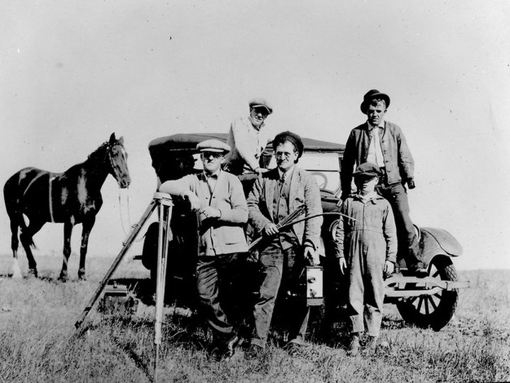  Vancouver filmmaker A.D. (Cowboy) Kean, with camera, and his assistant J.R. Nesbit, with tripod, pose with others while filming Policing the Plains at Buffalo National Park, near Wainwright, Alta., in October 1925. BC Archives G-08578