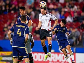 FC Dallas' Petar Musa (9) goes up for a header against Vancouver Whitecaps' Brian White, right, Mathias Laborda, back left, and Ranko Veselinovic (4) during the first half of an MLS soccer match, Saturday, March 16, 2024, in Frisco, Texas.