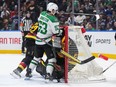 Dallas Stars' Wyatt Johnston (53) collides with Vancouver Canucks goalie Casey DeSmith and is given a goalie interference penalty during the first period of an NHL hockey game in Vancouver, on Thursday, March 28, 2024.