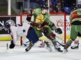 Handout photo of Damian Palmieri trying to get the puck away from the front of the Vancouver Giants' net with help from Connor Dale (No. 12) in a Feb. 5 game against the Tri-City Americans at the Langley Events Centre.