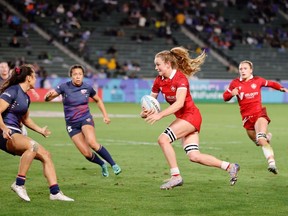Canada's Carissa Norsten, centre right, attacks the U.S defence on Day 2 of the HSBC SVNS Los Angeles in Carson, Calif., in a Saturday, March 2, 2024, handout photo. The Americans won the group game 22-19.