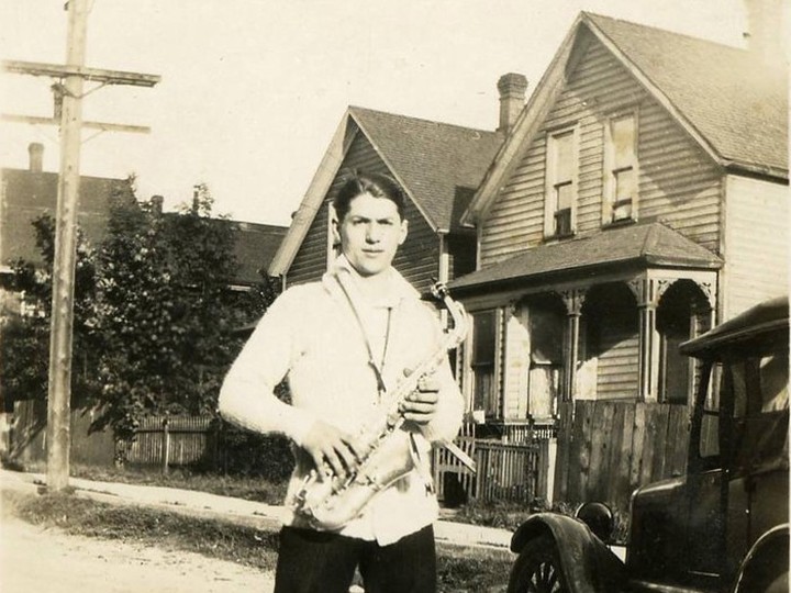  Gillie Brandolini out front of 507 Prior St. in Vancouver with a saxophone.