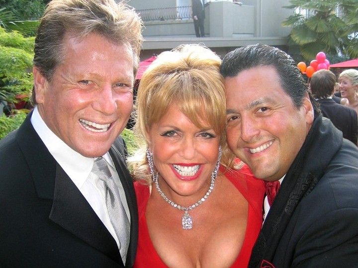  A Malcolm Parry column photo from June 10, 2006, Original cutline: “Jacqui Cohen wore a possibly-real $30-million diamond beside Face The World guests Ryan O’Neal and Alfredo Molina.