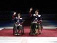 Ryan Straschnitzki, left, and Jacob Wassermann, victims of the Humboldt, Saskatchewan bus crash in 2017, are introduced in the first period of an NHL hockey game, in Denver on Saturday, Nov. 24, 2018.