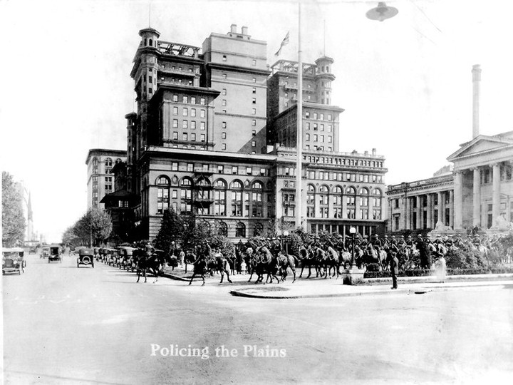  RCMP led by Asst. Commissioner T.A. Wroughton in one of the opening scenes of Cowboy Kean’s film Policing the Plains, May 1924. This still photograph shows the second Hotel Vancouver and the provincial courthouse, which is now the Vancouver Art Gallery. BC Archives H-01267