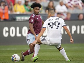 Colorado Rapids midfielder Ralph Priso, left, passes the ball as LA Galaxy forward Dejan Joveljic defends during the first half of an MLS soccer match Saturday, July 16, 2022, in Commerce City, Colo. The Vancouver Whitecaps have acquired Canadian midfielder Priso from the Colorado Rapids.