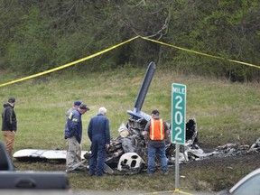 Investigators look over a small plane crash alongside eastbound Interstate 40 at mile marker 202 on Tuesday, March 5, 2024, in Nashville, Tenn. U.S. authorities continue to investigate a plane crash in Tennessee that killed five Canadians.