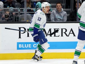 Canucks centre Teddy Blueger celebrates his goal and 100th career NHL point on Nov. 24 in Seattle.