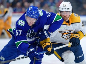 Kiefer Sherwood #44 of the Nashville Predators checks Tyler Myers #57 of the Vancouver Canucks in Game One of the First Round of the 2024 Stanley Cup Playoffs at Rogers Arena on April 21, 2024 in Vancouver.