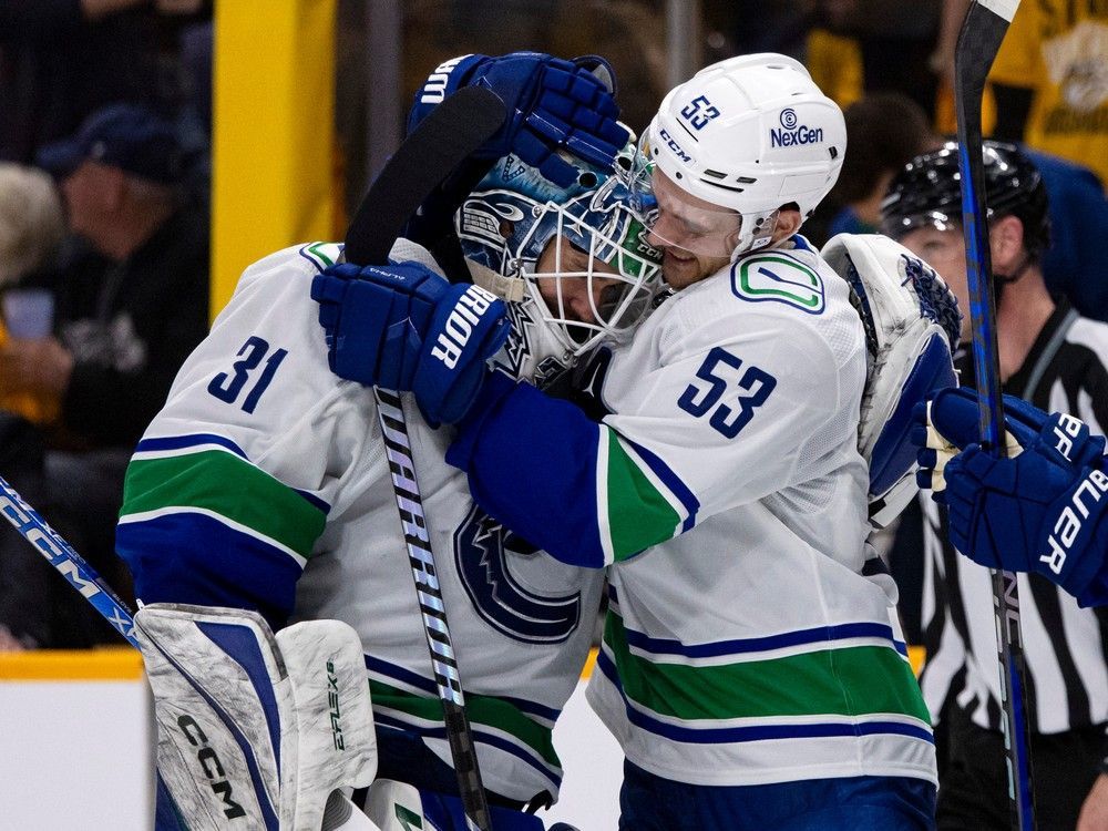Teddy Blueger gives Arturs Silovs a big victory hug after he backstopped a 4-3 overtime win Sunday in Nashville.