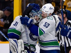 Teddy Blueger gives Arturs Silovs a big victory hug after he backstopped a 4-3 overtime win Sunday in Nashville.
