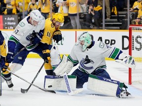 Canucks goalie Casey DeSmith makes a third-period save Friday to backstop a 2-1 playoff victory over the Predators in Nashville.