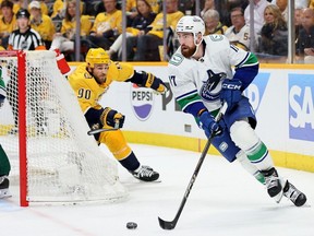 Filip Hronek of the Vancouver Canucks controls the puck against the Nashville Predators in game three of the First Round of the Eastern Conference NHL Stanley Cup Playoffs at Bridgestone Arena on April 26, 2024 in Nashville, Tennessee.