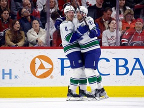 Canucks forward Elias Lindholm celebrates his second goal of the game against the Hurricanes with Brock Boeser in Raleigh, N.C. on Feb. 6.