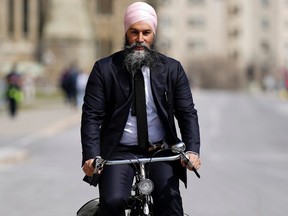 NDP Leader Jagmeet Singh arrives to Parliament Hill on his bicycle in Ottawa on Tuesday, April 9, 2024.