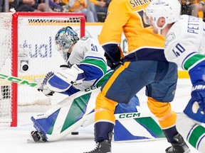 Canucks goaltender Arturs Silovs scrambles to smother the puck during Game 4 of playoff series against the Predators in Nashville on Sunday.