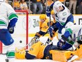 Brock Boeser (left) beats Nashville Predators goaltender Juuse Saros (74) at the end of the third period to tie the game. The Canucks won 4-3 in overtime.