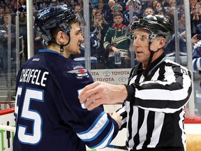 Linesman Brad Lazarowich #86 shakes hands with Mark Scheifele #55 of the Winnipeg Jets after officiating the final game of his career between the Jets and the Minnesota Wild at the MTS Centre on April 3, 2016 in Winnipeg, Manitoba, Canada.
