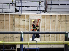 An employee works on a modular home component at NRB Modular Solutions in Calgary, Friday, April 5, 2024. The Canadian government will allow 30-year amortization periods on insured mortgages for first-time homebuyers purchasing newly built homes.
