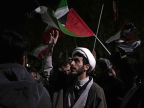 A cleric chants slogans during an anti-Israeli gathering in front of the British Embassy in Tehran, Iran, early Sunday, April 14, 2024. Iran launched its first direct military attack against Israel on Saturday.