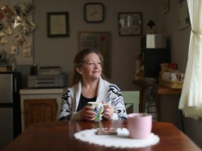 Local resident and postmistress for Canada Post, Yvonne Malanfant, looks out at the village during coffee in Zeballos, B.C., on Wednesday, April 10, 2024.