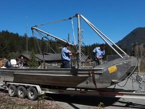 Deckhands from the Homalco First Nations ready a seine boat out front of the Ehattesaht First Nation's band office in Zeballos, B.C., Thursday, April 18, 2024. The arrival of a large seine fishing vessel capable of casting a net strong enough to hold an almost 700 kilogram killer whale calf has arrived in Zeballos, B.C. to participate in the expected latest attempt to rescue a young orca stranded in a remote tidal lagoon.