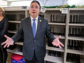 Dale Nally, minister of Service Alberta and Red Tape Reduction, tours the Land Titles office where shelves used to be filled with files that had not been processed, and now sit empty, after providing an update on processing times at the office on Monday, Dec. 4, 2023 in Edmonton.