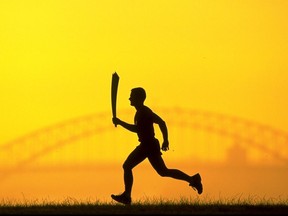 23 Mar 1999: The 2000 Sydney Olympic Games Torch silhouetted against Sydney Harbour Bridge. Mandatory Credit: Nick Wilson /Allsport