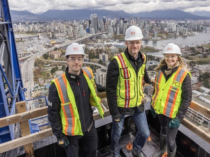  From left, Seb Roy-Foster, Tim Grant and Kate O’Neil of PCI Developments on the tower under construction at Broadway and Granville in Vancouver.