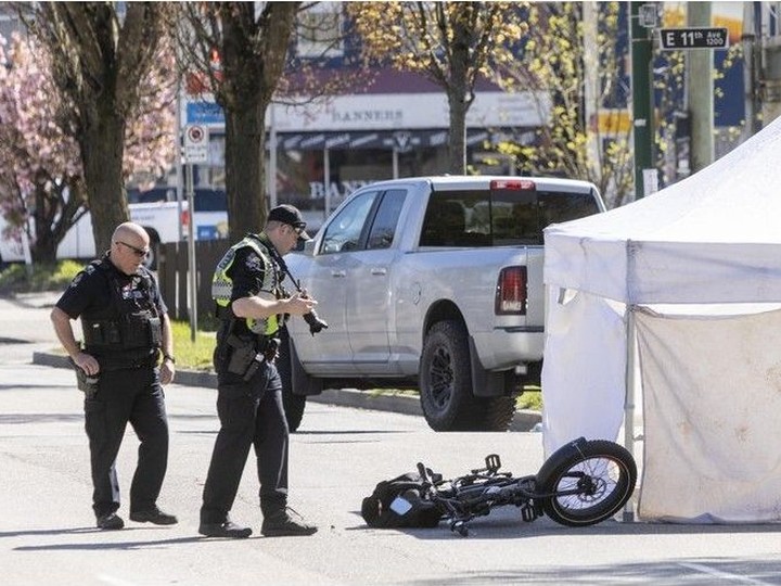  Vancouver Police inspect an accident at Clark Drive and East 11th in Vancouver on April 17, 2024.