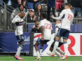 Vancouver Whitecaps' Fafa Picault, from left to right, Ali Ahmed, Ryan Gauld and Damir Kreilach celebrate Picault's goal against the Portland Timbers during the first half of an MLS soccer match, in Vancouver, on Saturday, March 30, 2024.