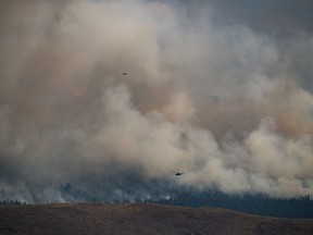 British Columbia's wildfire season is off to an early start with parts of the central province under two evacuation alerts. Helicopters fly past the Tremont Creek wildfire as it burns on the mountains above Ashcroft, B.C., on Friday, July 16, 2021.
