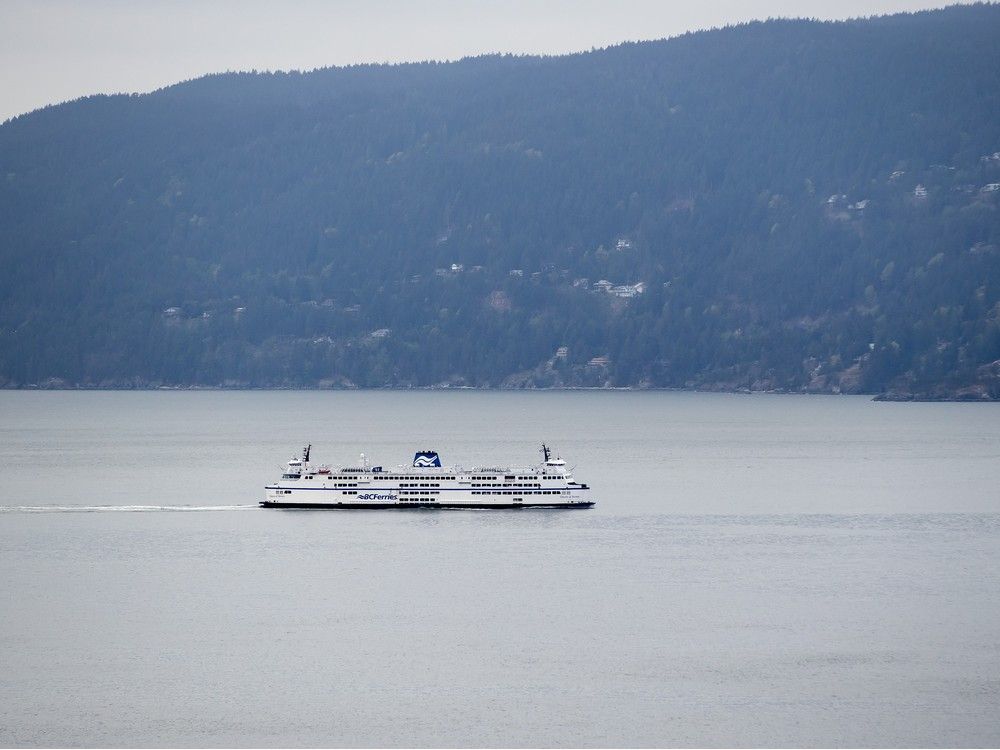 The B.C. Ferries vessel Queen of Surrey passes Bowen Island while traveling on Howe Sound from Horseshoe Bay to Langdale.