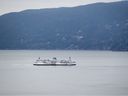 The B.C. Ferries vessel Queen of Surrey passes Bowen Island while traveling on Howe Sound from Horseshoe Bay to Langdale.