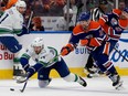 The Edmonton Oilers' Derek Ryan battles the Vancouver Canucks' Pius Suter during NHL playoff in Edmonton May 18.