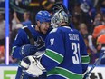 Canucks rookie Arturs Silovs is congratulated by Dakota Joshua after backstopping a 5-4 comeback playoff series win over the Oilers in Game 1 on Wednesday.
