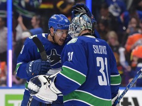 Dakota Joshua and Arturs Silovs of the Vancouver Canucks celebrate their win against the Edmonton Oilers in Game One of the Second Round of the 2024 Stanley Cup Playoffs at Rogers Arena.