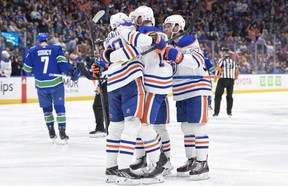Mattias Ekholm of the Edmonton Oilers celebrates with teammates after scoring a goal against the Vancouver Canucks during the second period in Game Two of the Second Round of the 2024 Stanley Cup Playoffs at Rogers Arena on May 10.