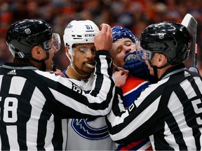 Dakota Joshua, left, of the Vancouver Canucks and Corey Perry of the Oilers get into an altercation during the second period in Game 3 of the second round of the Stanley Cup playoffs at Rogers Place on May 12 in Edmonton.