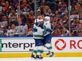 Canucks centre Elias Lindholm celebrates with teammates after his goal during the second period against the Oilers on Sunday.