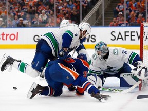 Canucks sensational rookie stopper Arturs Silovs makes a save on Oilers superstar Connor McDavid during the second period Sunday.