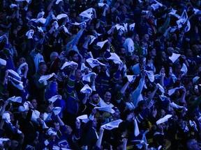Fans wave towels before Game 2 of Vancouver Canucks vs. Nashville Predators at Rogers Arena on April 23. The atmosphere should be just like a home game during a Game 6 viewing party there on May 3.