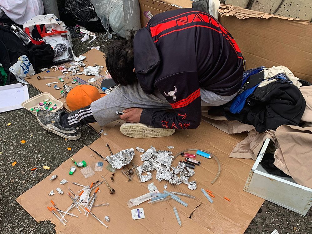 A drug user slumps in a back lane in Vancouver in a file photo from May 31, 2022. British Columbia decriminalized hard drugs for personal consumption on Jan. 31, 2023.
