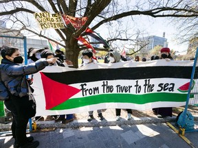 Protesters at the University of Toronto hold a banner with the slogan “from the river to the sea,” which some view as a call for the destruction of the state of Israel. Newly obtained documents show Muslim and Jewish groups have seen a rise in hate speech since the start of the Israel-Hamas war.