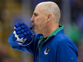 Vancouver Canucks head coach Rick Tocchet blows a whistle during the opening day of the NHL hockey team's training camp, in Victoria, Thursday, Sept. 21, 2023.