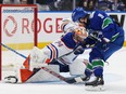 Canucks winger Conor Garland goes hard to the net on Oilers goalie Stuart Skinner during May 8 playoff matchup at Rogers Arena.